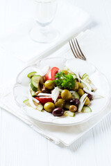 Various olives on white wooden background. Close up. Copy space