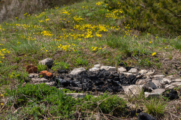 Abandoned extinct stone hearth for bonfire. Survival in wild. Protecting forest from spread of fire