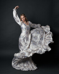 portrait of beautiful blonde female model wearing romantic historical gown white bridal floral...