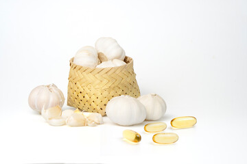 Garlic in bamboo basket and granulated garlic extract Isolated from the white background.