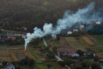 agricultural waste bonfires from dry grass and straw stubble burning with thick smoke polluting air...