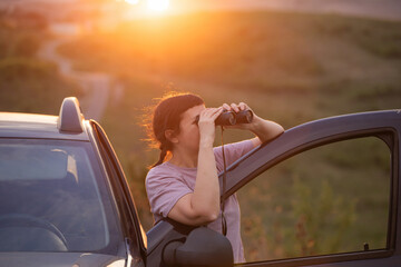 Happy woman looking through binoculars