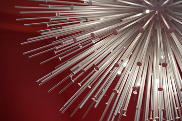 photo of a group of white metal rods on a red background