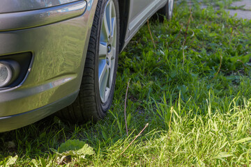 Front and side bottom car part with wheel on meadow