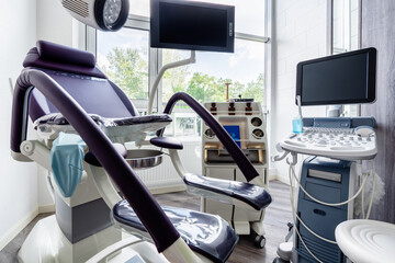 Gynecologist's chair and ultrasound machine in a gynecologist clinic