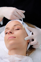 Medical cosmetology treatments. Young woman receiving botox injection at beauty clinic, closeup.