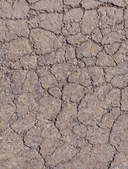 Texture of old asphalt road surface covered with web of cracks. Topics of transport and repair of old roads.