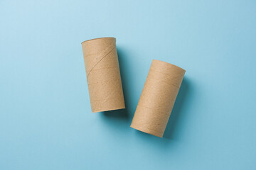 Top view of two empty toilet paper rolls on blue background