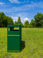 A bin at the middle of grass area in a park (Cardiff, Wales, United Kingdom)