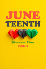 Juneteenth-themed top view vertical photo featuring hearts in red, green, black on yellow,...