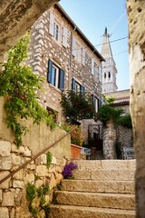 Rovinj, Croatia. Stone paved street inside the old town with view of St. Euphemia church.