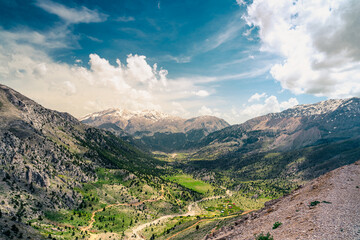 Naklejka premium The lush green Sobucimen plateau in spring and the mountains with some melted snow behind.