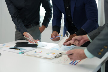 Business teamwork discussing brainstorming and calculating with a calculator on evaluation data in the conference room Focus on business growth and point out financial accounting charts.