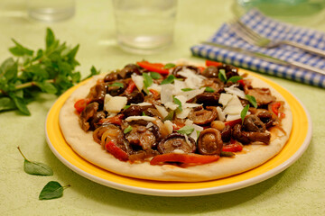 Homemade pizza with shiitake mushrooms.