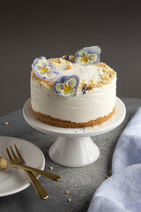 cheesecake on a gray background with light blue, purple and yellow flowers