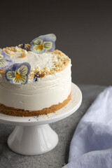 cheesecake on a gray background with light blue, purple and yellow flowers