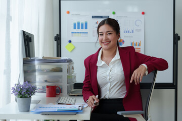 Asian businesswoman sitting relaxing working with PC on table Online finance, documents, accounting, taxes, reports, marketing, statistics, business analysis research concepts.