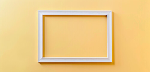 White frame for paintings or photographs on light goldenrod yellow background, modern exhibition concept,