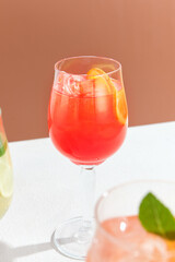 Refreshing Aperol Spritz Cocktail with Orange Garnish in Wine Glass Against Warm Background