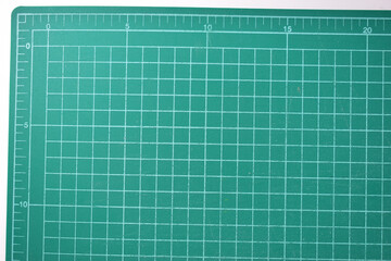 green cutting mat board on white background with line and scale measure guide pattern for object art design, tool equipment of diy craft work