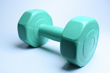 single green dumbbell on white background, object for exercise