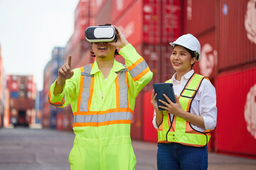 worker or engineer wearing virtual reality glasses(VR) in containers warehouse storage