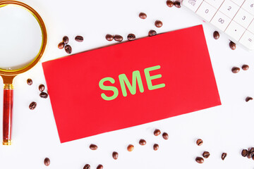 SME abbreviation of Small and Medium Enterprises. Copy space. Text SME on a red card on a white...
