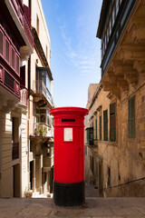 red post box in the middle of the street