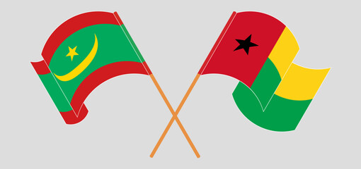 Crossed and waving flags of Mauritania and Guinea-Bissau