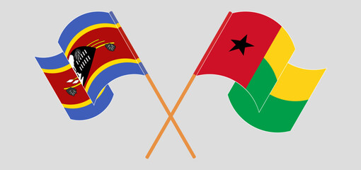 Crossed and waving flags of Eswatini and Guinea-Bissau