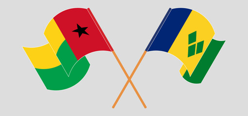 Crossed and waving flags of Guinea-Bissau and Saint Vincent and the Grenadines