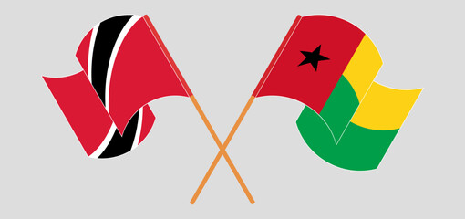 Crossed and waving flags of Trinidad and Tobago and Guinea-Bissau