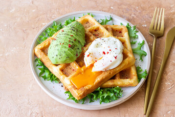 Belgian waffles with avocado and poached egg. Healthy eating. Vegetarian food. Breakfast.
