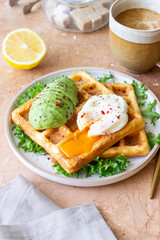 Belgian waffles with avocado and poached egg. Healthy eating. Vegetarian food. Breakfast.
