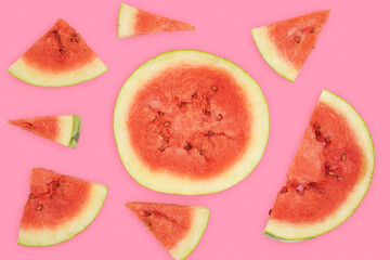 Summer fruit background concept, different cuts of watermelon against pink background