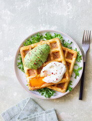 Belgian waffles with avocado and poached egg. Healthy eating. Vegetarian food. Breakfast.