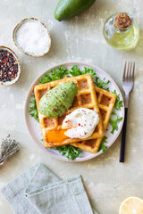Belgian waffles with avocado and poached egg. Healthy eating. Vegetarian food. Breakfast.