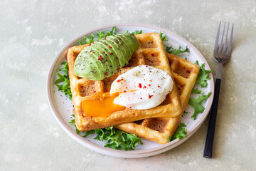 Belgian waffles with avocado and poached egg. Healthy eating. Vegetarian food. Breakfast.