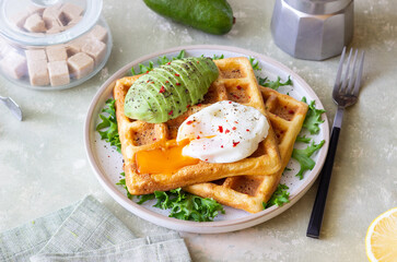 Belgian waffles with avocado and poached egg. Healthy eating. Vegetarian food. Breakfast.