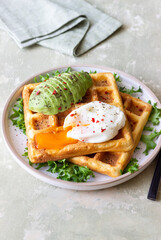 Belgian waffles with avocado and poached egg. Healthy eating. Vegetarian food. Breakfast.