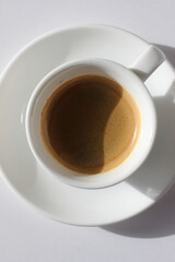 Freshly Made Espresso Shot with Crema Foam on White Background. Specialty Coffee.
