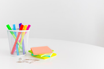 Office desk table with supplies, sticky notes and coloured pens. Top view with copy space. Flat...