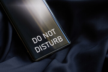 Do not disturb - the inscription on the screen of a modern smartphone - mobile phone. Dark...