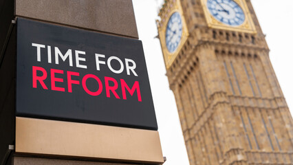 Time For Reform written on a sign with Elizabeth Tower and Big Ben in the background