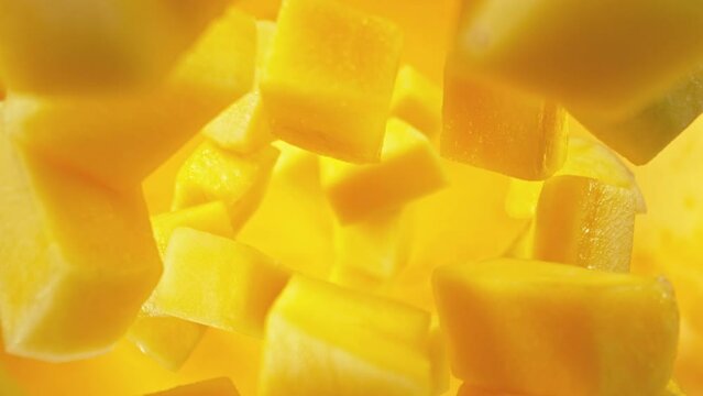 Super Slow Motion of Falling Mango Pieces into Water. Filmed on High Speed Cinema Camera, 1000fps, Placed on High Speed Cine Bot. Camera in Motion, Following Objects.