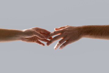 Hands of male and female holding together. Woman and man holding hands together. Giving a helping...