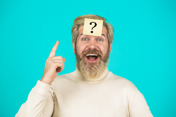 Man with question mark on forehead. Paper notes with question marks. Beard man question mark in...
