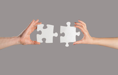 Puzzles. Man and woman holds in hand a jigsaw puzzle. Business solutions, success and strategy...