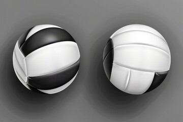 Two white and black volleyball balls on a gray surface. Suitable for sports and recreation concepts