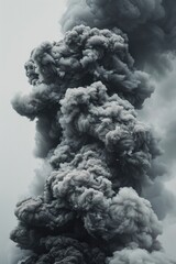 A striking black and white photo of a large plume of smoke. Ideal for illustrating environmental issues or emergency situations
